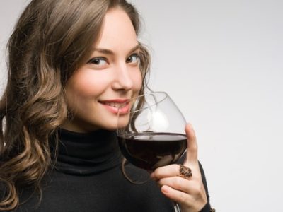 fashionable young brunette woman tasting great wine.