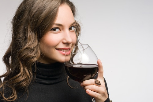 fashionable young brunette woman tasting great wine.
