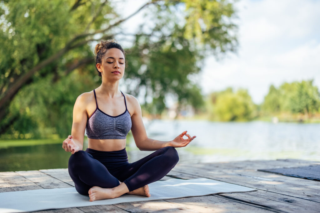 Young,Woman,,Meditating,In,The,Nature,,Alone,,While,Relaxing.