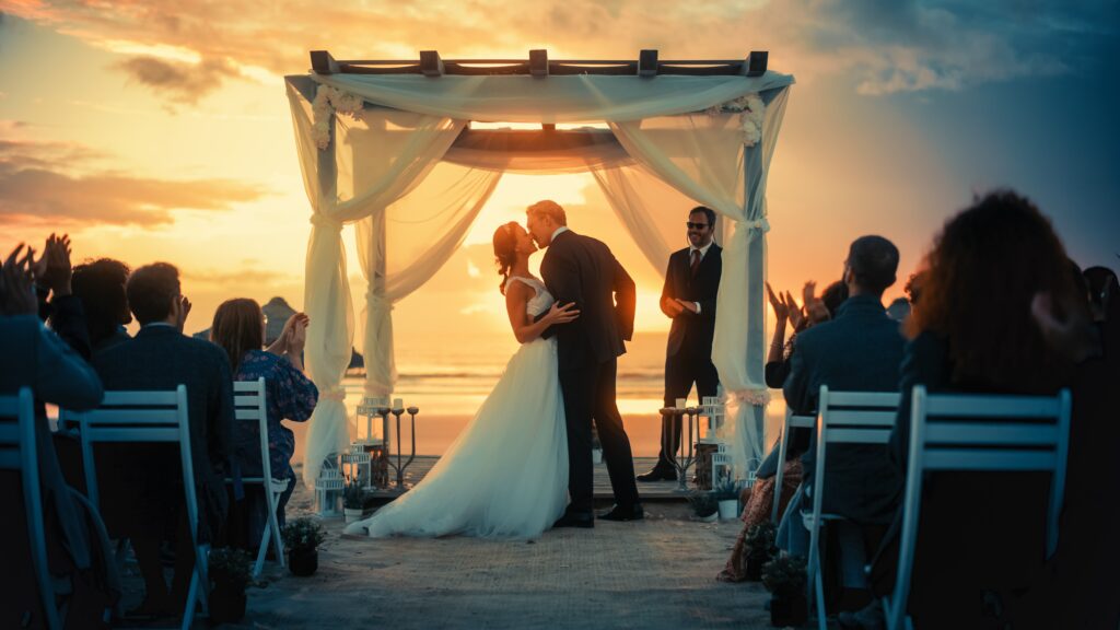 Bride and groom during sunset beach wedding ceremony, symbolizing special moments and radiant skin enhanced by GentleMax Pro skin rejuvenation treatments